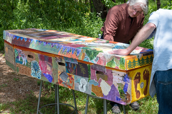 cardboard coffin decorated with colorful paper and paint