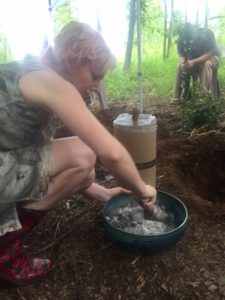 Daughter mixing cremated remains with soil amendment.