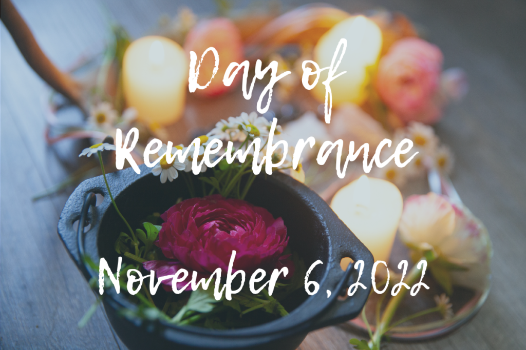 Image of flowers and candles blurred with text "Day of Remembrance, November 6, 2022"