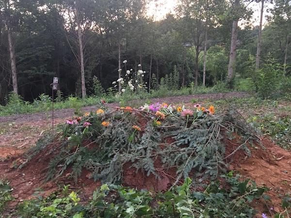 Kathy's closed grave with flowers on top.